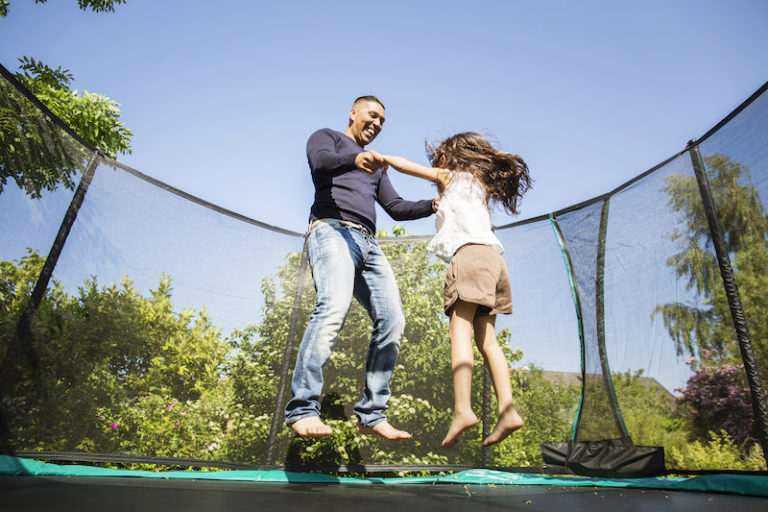 family jumping on trampoline during covid lockdown