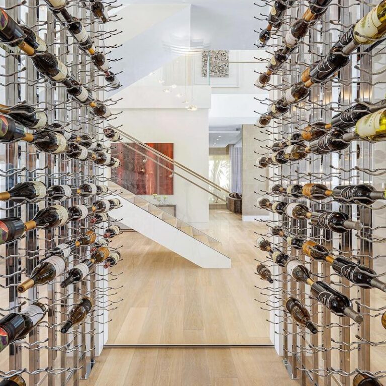 metal wine storage display with wine labels facing forward in modern home