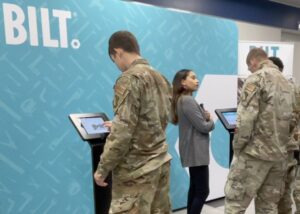 Three US Air Force personnel examine the BILT app on iPads at a recent military readiness training show
