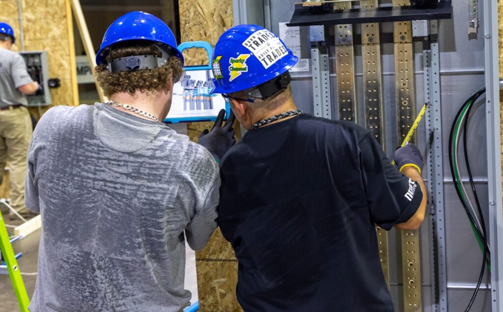 Two electrician apprentices use the BILT app for upskilling and workforce learning