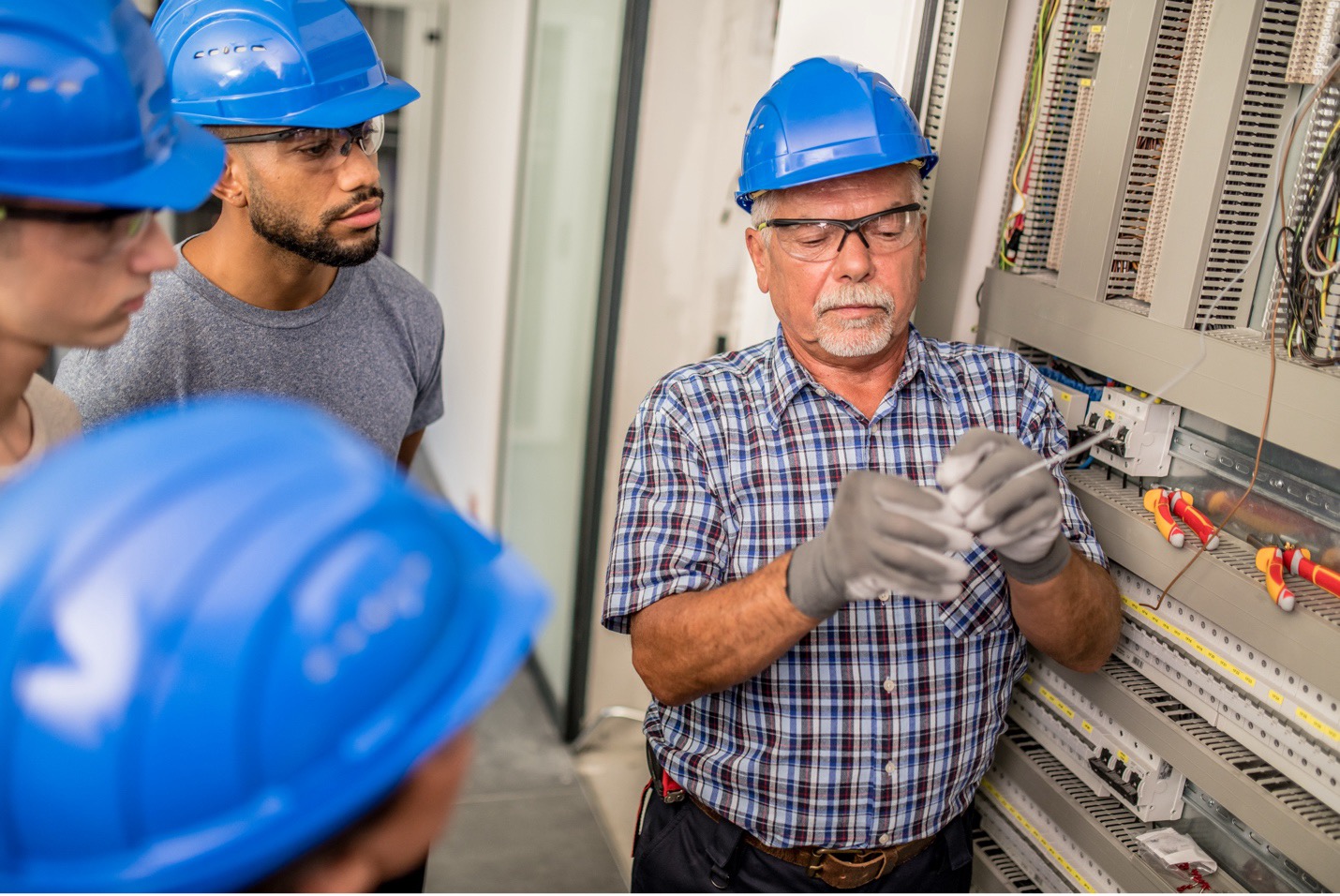a group of men wearing hard hats during electrical training
